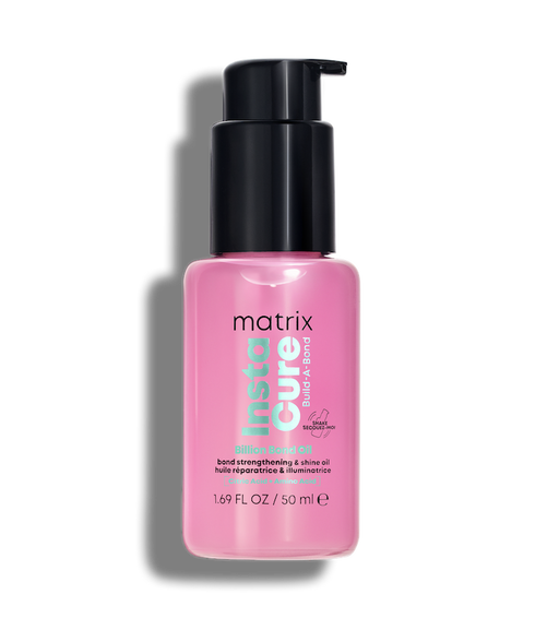 Pink bottle of Matrix Insta Cure hair oil on a white background