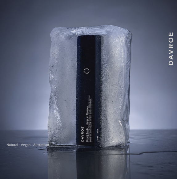 Black Davroe product encased in ice on a reflective surface with a gray background