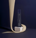 Hair product bottle on a stand with blonde hair strands against a dark background