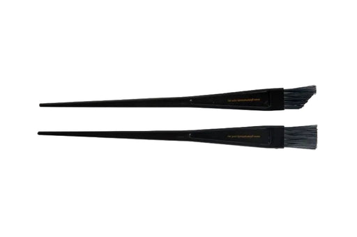 Two black tint brushes for hair colouring laid out on a white background.