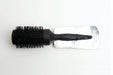 A black jumbo brush with a carbon-coated surface, displayed on a white background, packaged with a label.