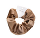 Brown scrunchie with a tag on a white background