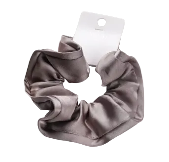 Brown scrunchie on a white surface with a measurement label