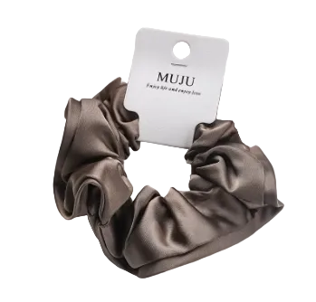 Brown satin scrunchie with MUJU label on a white background