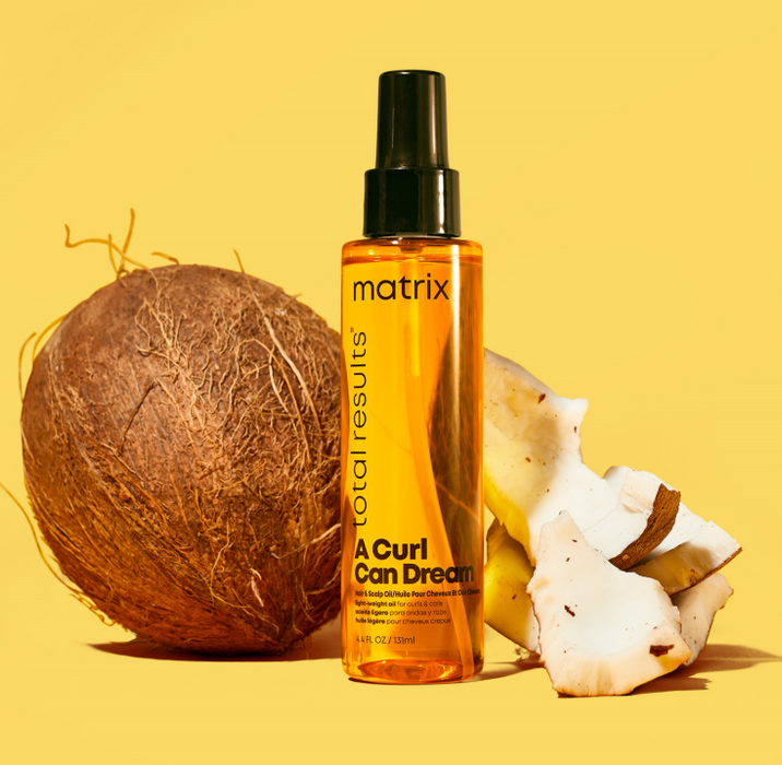 Matrix Total Results hair care product with a coconut and coconut shell on a yellow background