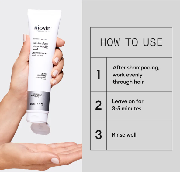 Nioxin hair mask tube held in a hand with usage instructions on a gray background