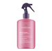 A pink bottle of Pureology Smooth Gloss SilkMorphose Spray with a dark purple trigger sprayer, set against a solid white background.