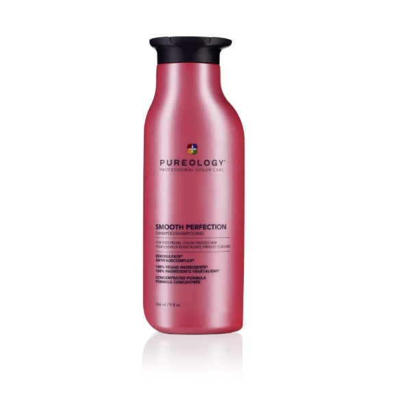 Red shampoo bottle with black cap on a white background