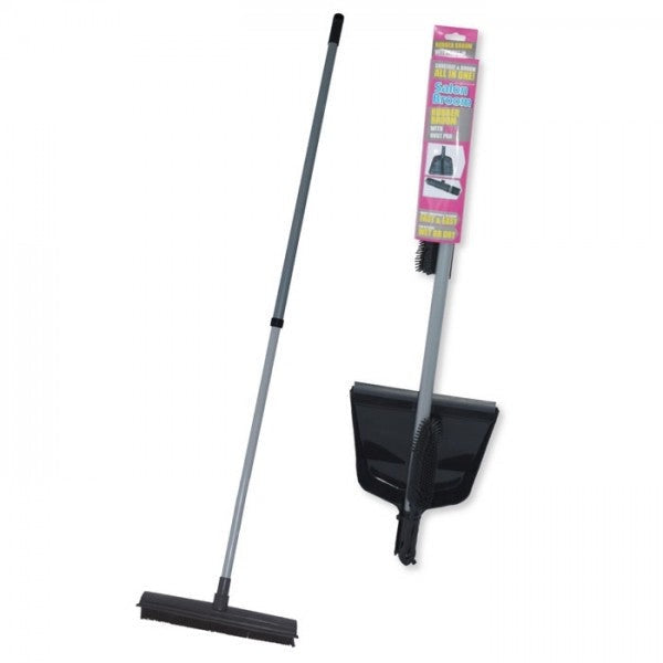 A black salon broom with a dustpan attached to a long handle, standing upright against a pink background with product information.